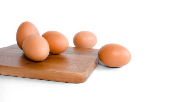 istock fresh organic chicken eggs. on brown cutting board, 1452302936