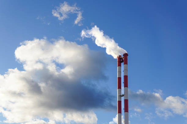 istock Red-white strips chimneys with smoke against sky with cloud, ecological concept 1452305059