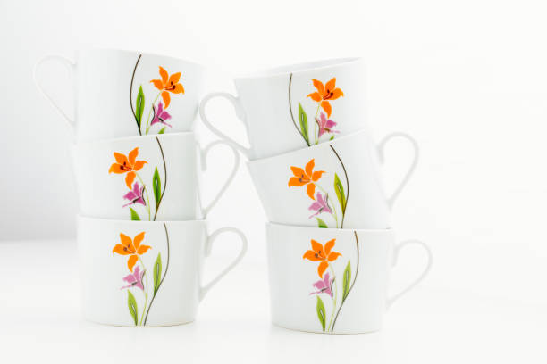 set of tea cups with flowers on a white background. beautiful tableware for the house. kitchen accessories store.