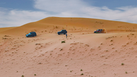 Three cars along the dunes in the Nafud desert of Saudi Arabia