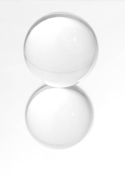 istock Glass ball on a mirrored surface and white background. 1452313814