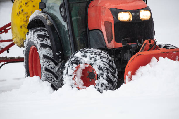 istock Tractor cleaning urban park paths on a cold snowy day. 1452313956