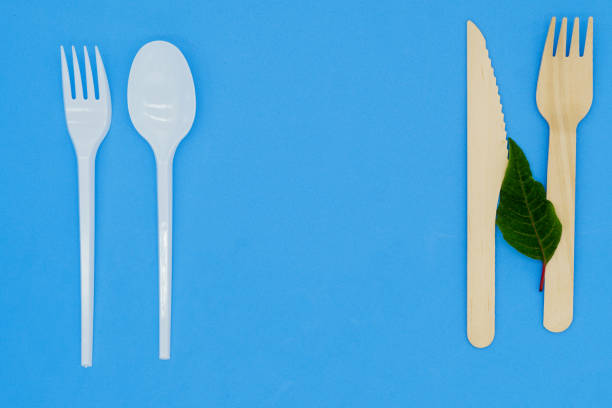 istock Disposable wooden fork and knife on blue background. Eco-friendly materials. No single-use plastics. Save the planet 1452314871