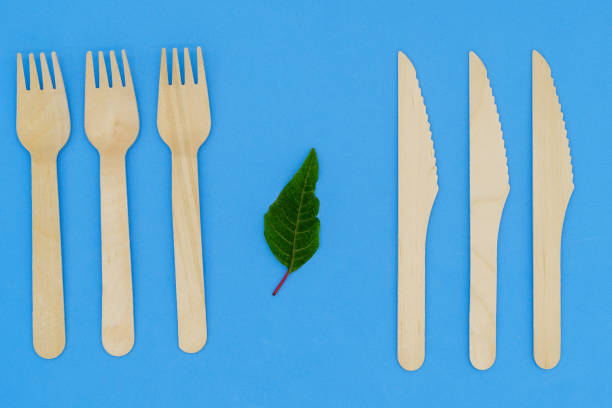 istock Disposable wooden fork and knife on blue background. Eco-friendly materials. No single-use plastics. Save the planet 1452315665