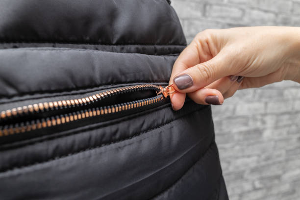 istock woman opens a zipper lock with her hand 1452318169