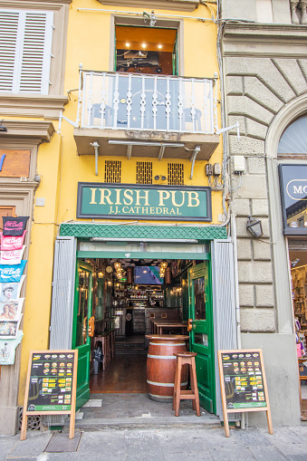 Commercial signs visible at JJ Cathedral Irish Pub on Piazza di San Giovanni in Florence at Tuscany, Italy
