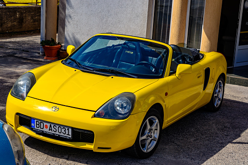 Unique 3d modelled brandless, generic sports car in studio - isolated on white with clipping path