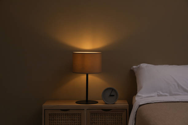 istock Stylish night lamp on bedside table in bedroom 1452319289