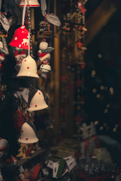 A visually engaging image featuring golden bells arranged on a vibrant red background, creating a festive and celebratory atmosphere. The design conveys themes of joy, holiday spirit, and decorative elegance.