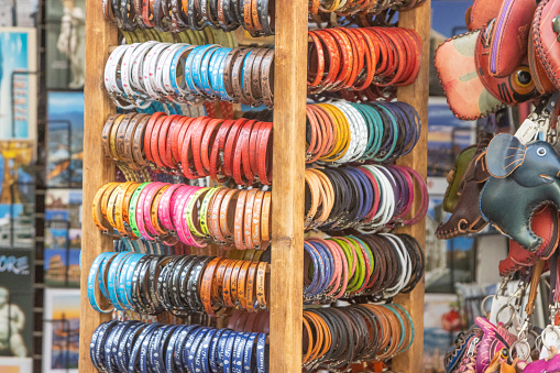 Bangles on display in Florence at Tuscany, Italy, with commercial symbols and logos visible.