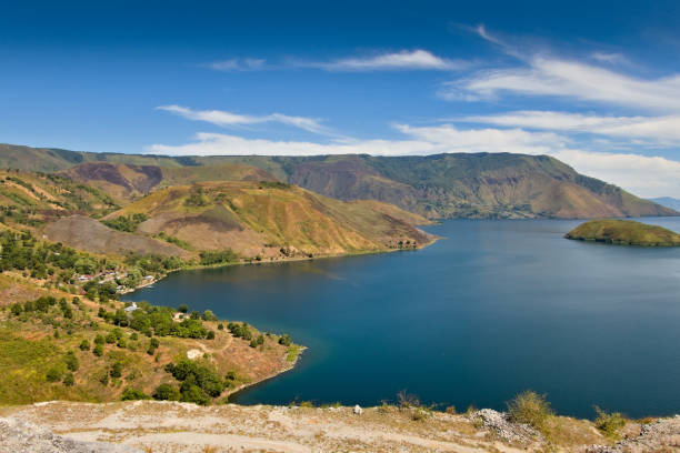 West coast of lake Toba with mountains in the background, North Sumatra, Indonesia West coast of lake Toba with mountains in the background, North Sumatra, Indonesia lake toba indonesia stock pictures, royalty-free photos & images