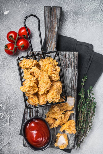 istock Dip Fried chicken popcorn with ketchup in a basket. White background. Top view 1452320651