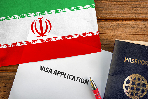 Visa application form, passport and flag of Iran