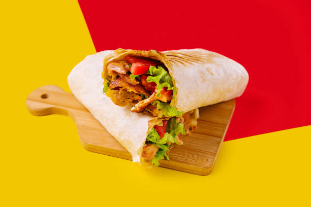 istock shawarma with chicken, tomatoes and lettuce on a wooden board 1452323201