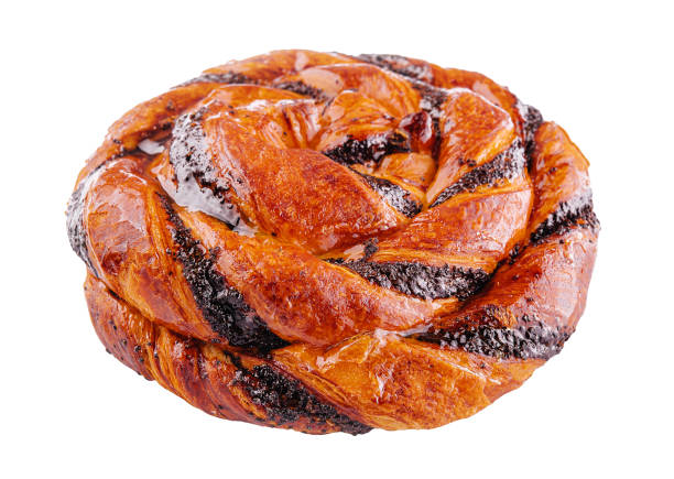 Round sweet twisted bun made with puff pastry with grated poppy seeds