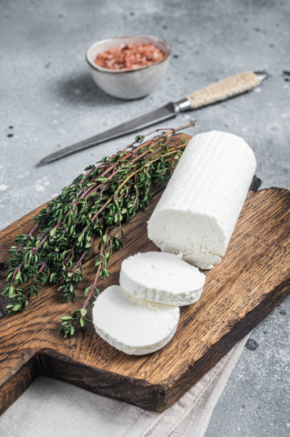 istock Fresh goat soft cheese with thyme. Gray background. Top view 1452324874
