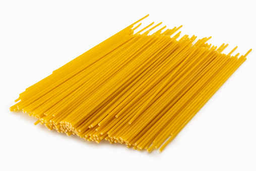 Typical italian bucatini pasta, big perforated spaghetti isolated on white