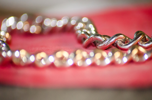 golden chain on a red cloth that looks blurry