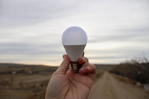 light bulb in male hand.