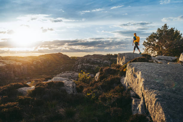 Woman hiking outdoors in Norway: summer adventures Woman hiking outdoors in Norway. Adventures in summer Norway, in the Bergen area. bergen norway stock pictures, royalty-free photos & images