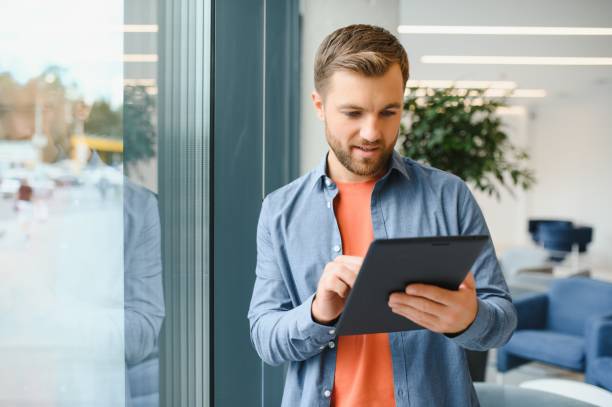 istock a freelancer man works with a tablet in a work coaching office 1452329911