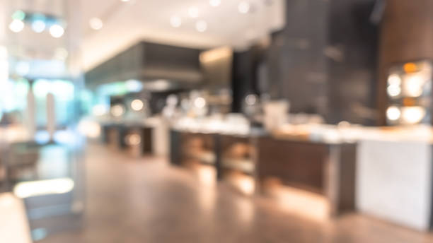 istock Buffet at hotel restaurant interior blur background with blurry open kitchen counter bar of food catering service business with chef staff cooking for breakfast, lunch or dinner meal 1452332021