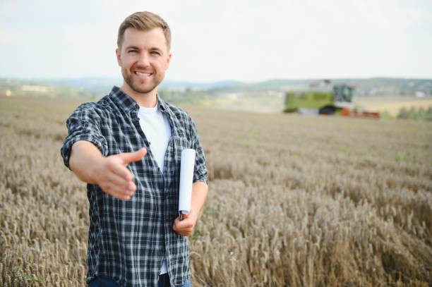 istock Young farmer in wheat field during harvest in summer 1452332117