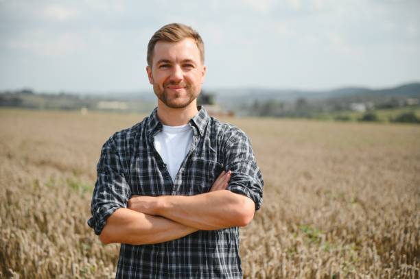 istock Farmer Standing In Wheat Field At Harvest. 1452332126