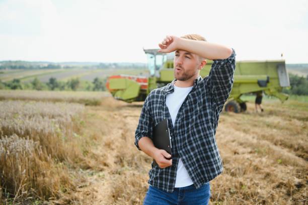 istock Farmer Standing In Wheat Field At Harvest 1452332758