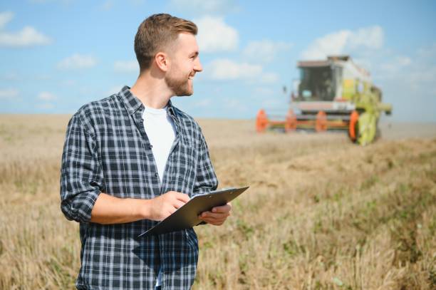 istock Farmer Standing In Wheat Field At Harvest 1452333015