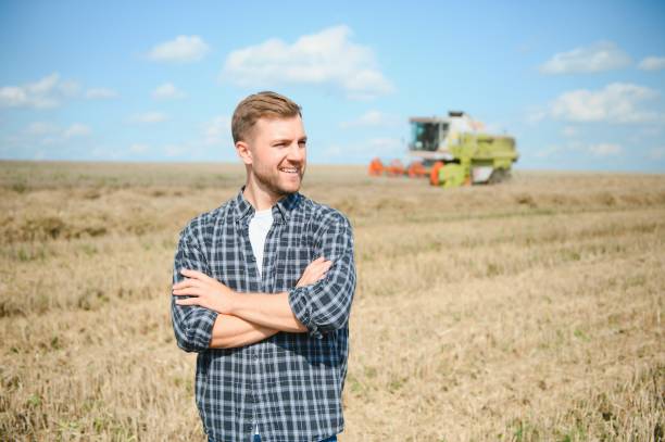 istock Farmer Standing In Wheat Field At Harvest 1452333119