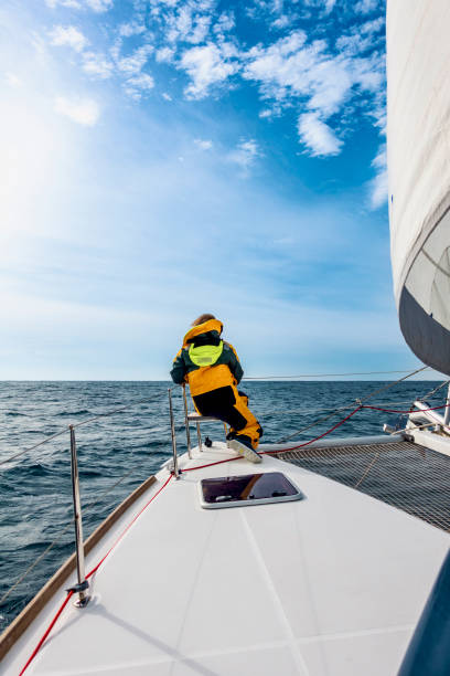 istock Female sailor keeping an eye out on a catamaran 1452333271