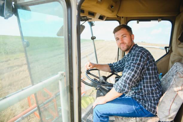 istock Farmer driving combine and harvesting crop. 1452333342