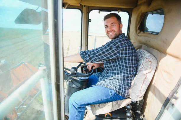 istock Farmer controls the combine harvester. 1452333344