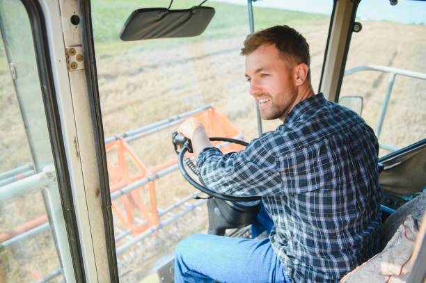 istock Farmer driving combine and harvesting crop. 1452333354