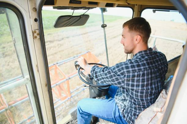 istock Farmer driving combine and harvesting crop. 1452333358