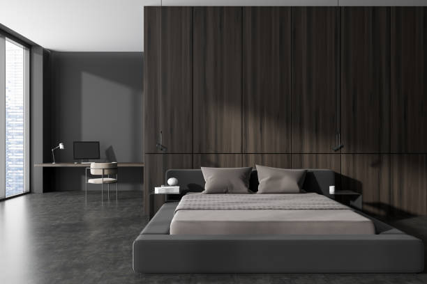 istock Front view on dark bedroom interior with bed, wardrobe, desk 1452336007
