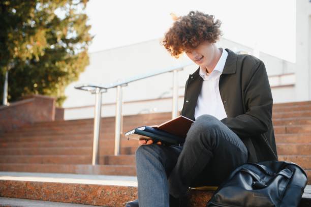 istock Excited student having break between classes near university, smiling to camera outdoors 1452336222