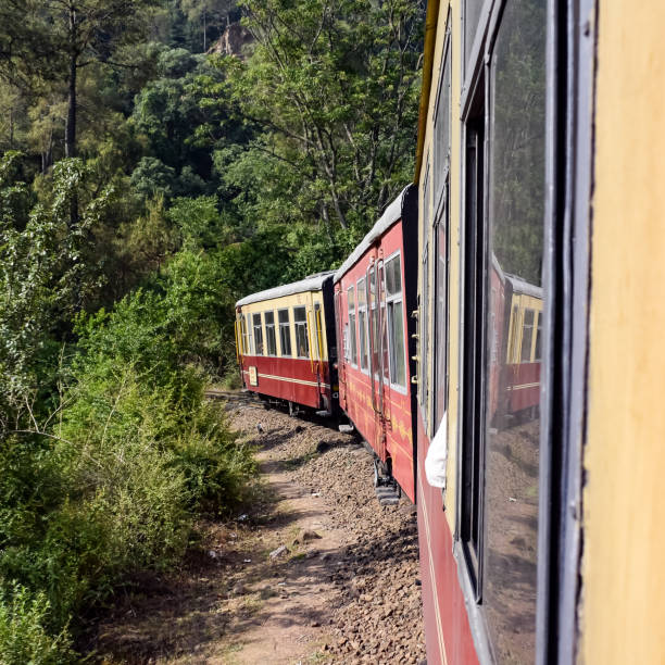 istock Toy Train moving on mountain slopes, beautiful view, one side mountain, one side valley moving on railway to the hill, among green natural forest. Toy train from Kalka to Shimla in India, Indian Train 1452337319