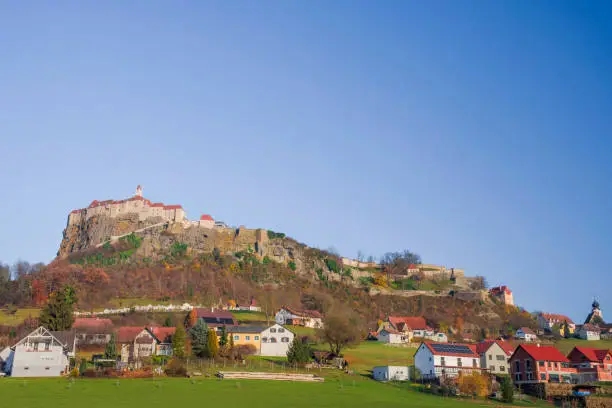 The medieval Riegersburg Castle on top of a dormant volcano, surrounded by charming little village and beautiful autumn landscape, famous tourist attraction in Styria region, Austria