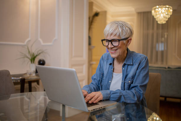 istock Senior woman working from home 1452338418
