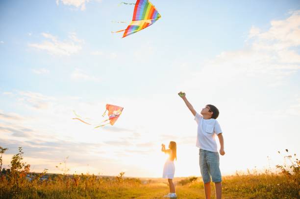 istock Children launch a kite in the field at sunset 1452341446