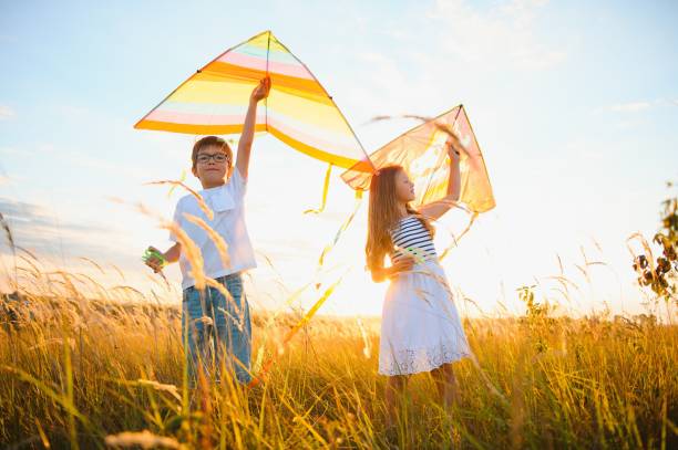 istock Children launch a kite in the field at sunset 1452341476