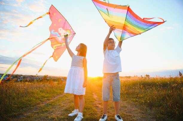 istock Children launch a kite in the field at sunset 1452341550