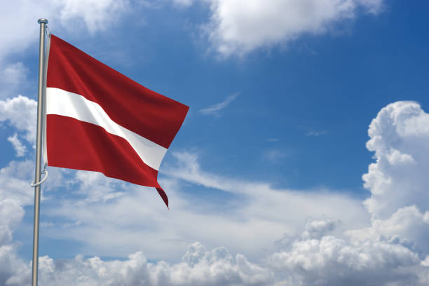 istock Republic of Latvia Flags Over Blue Sky Background. 3D Illustration 1452342580