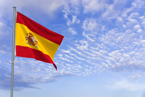 istock Kingdom of Spain Flags Over Blue Sky Background. 3D Illustration 1452342640