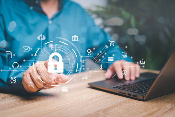 istock Cybersecurity concept, Businessman point to the padlock icon and internet technology network, Protection of personal data for business security and online transactions, and use the laptop on the table 1452348364