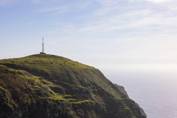 Amazing lighthouse on a high cliff on the Madeira coast in Portugal. stock photo