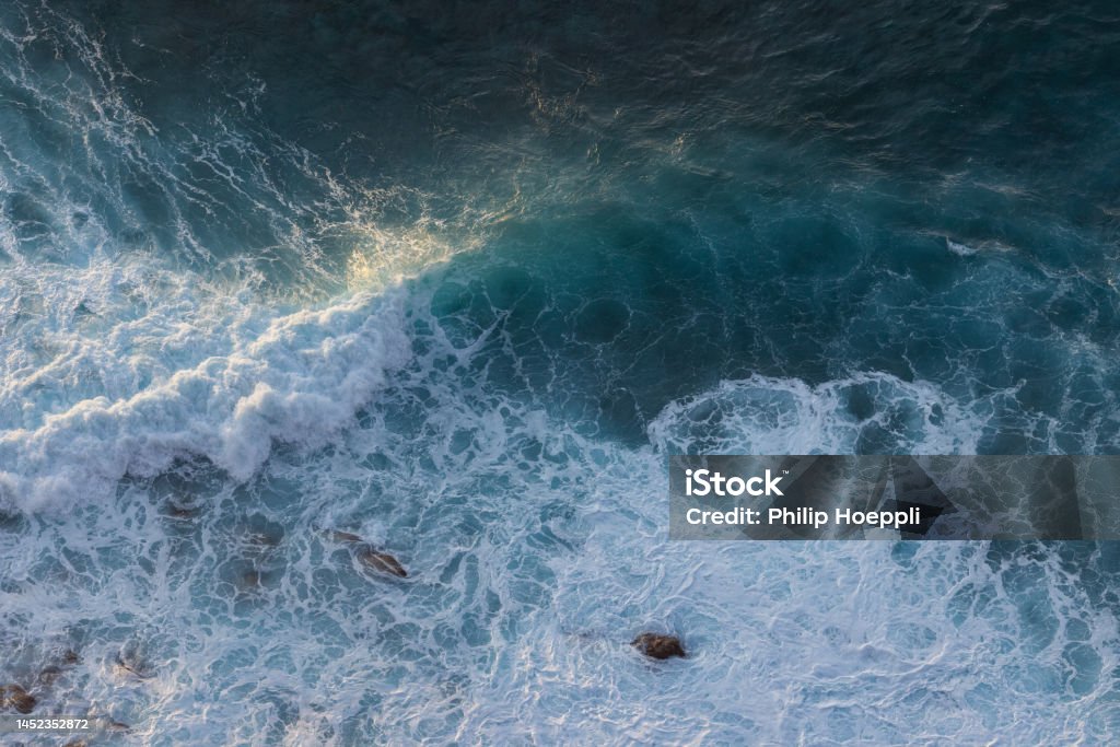 Epic waves in the Atlantic Ocean off the coast of Madeira off Morocco. Great sunset at the sea. Wonderful landscape in Portugal, Madeira. Aerial View Stock Photo