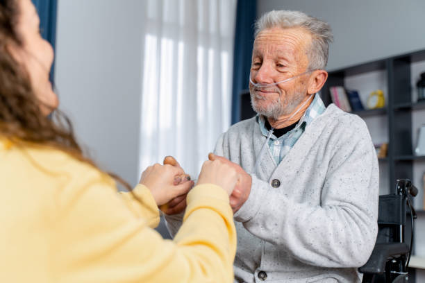 woman holding her senior father's hands